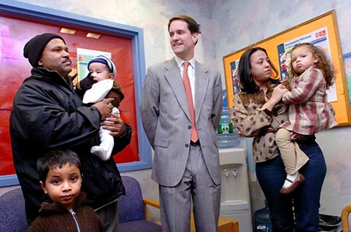 Congressman Jim Himes holds a press conference at the Norwalk Community Health Center on Thursday to speak about the new S-Chip law which will be providing many more children with health care. On the left is Nermal Das with his two sons Abir Das who is 6 months old and Arnob Das who is 5. On the right is China Garcia with 2 year old daughter Heaven Branch Garcia/hour photo matthew vinci