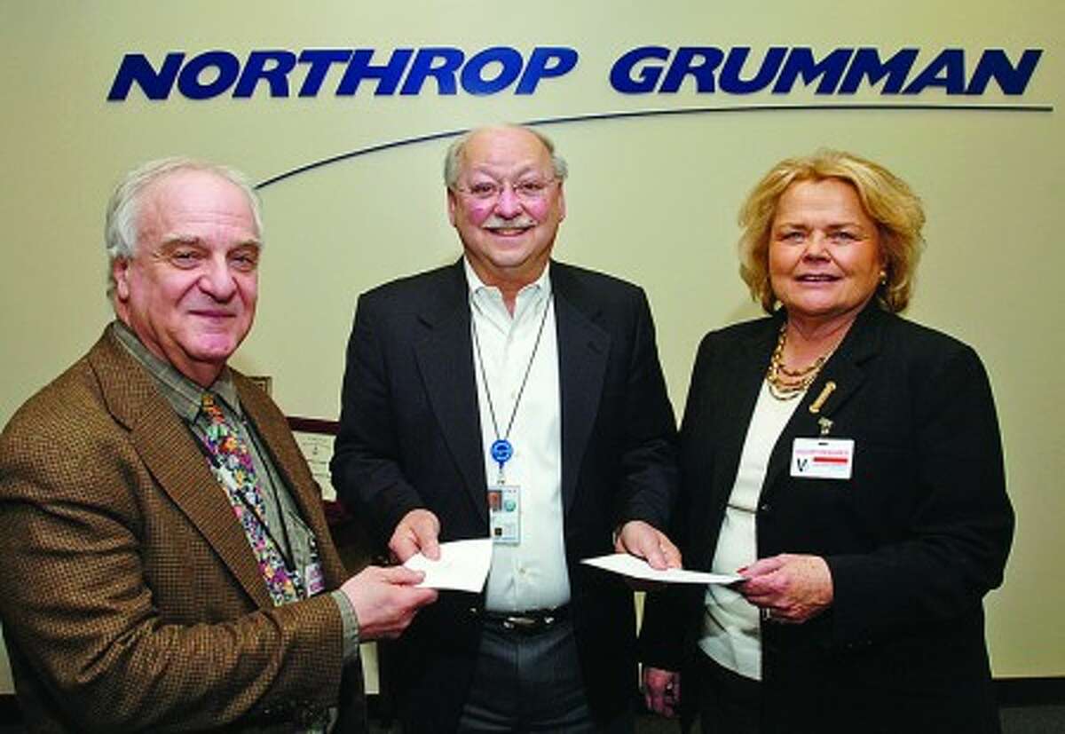 Site Director of Northrop Grumman Norden Systems, Tony Izzo, center, presents checks to Instructional Science Specialist for the Norwalk Public Schools, Ken Martinelli and Executive Director of the Human Services Council of Mid-Fairfield County, Betty Karkut, for $1800 and $5000 respectively for the NPS All City Science Fair and HSC Mentoring programs. Hour photo / Erik Trautmann