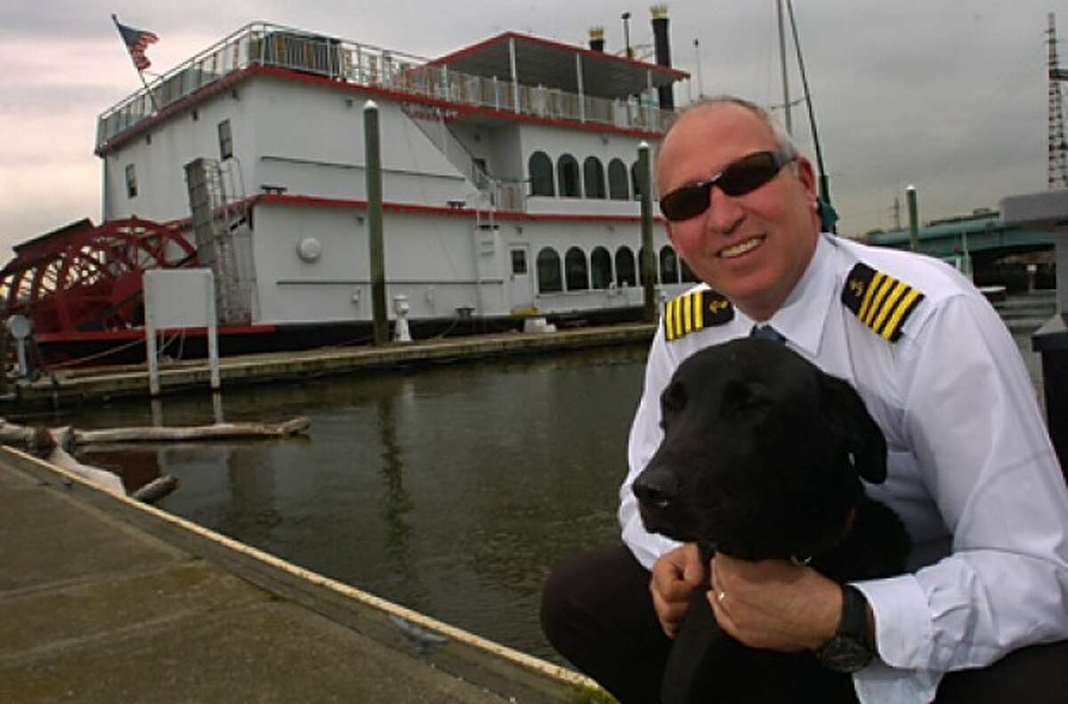 Captain Ken Hart, his dog, Pierce, with his boat the Island Belle, which will start ferrying between Northport Long Island and South Norwalk this summer along with charter avalability for special events. Hour photo / Erik Trautmann