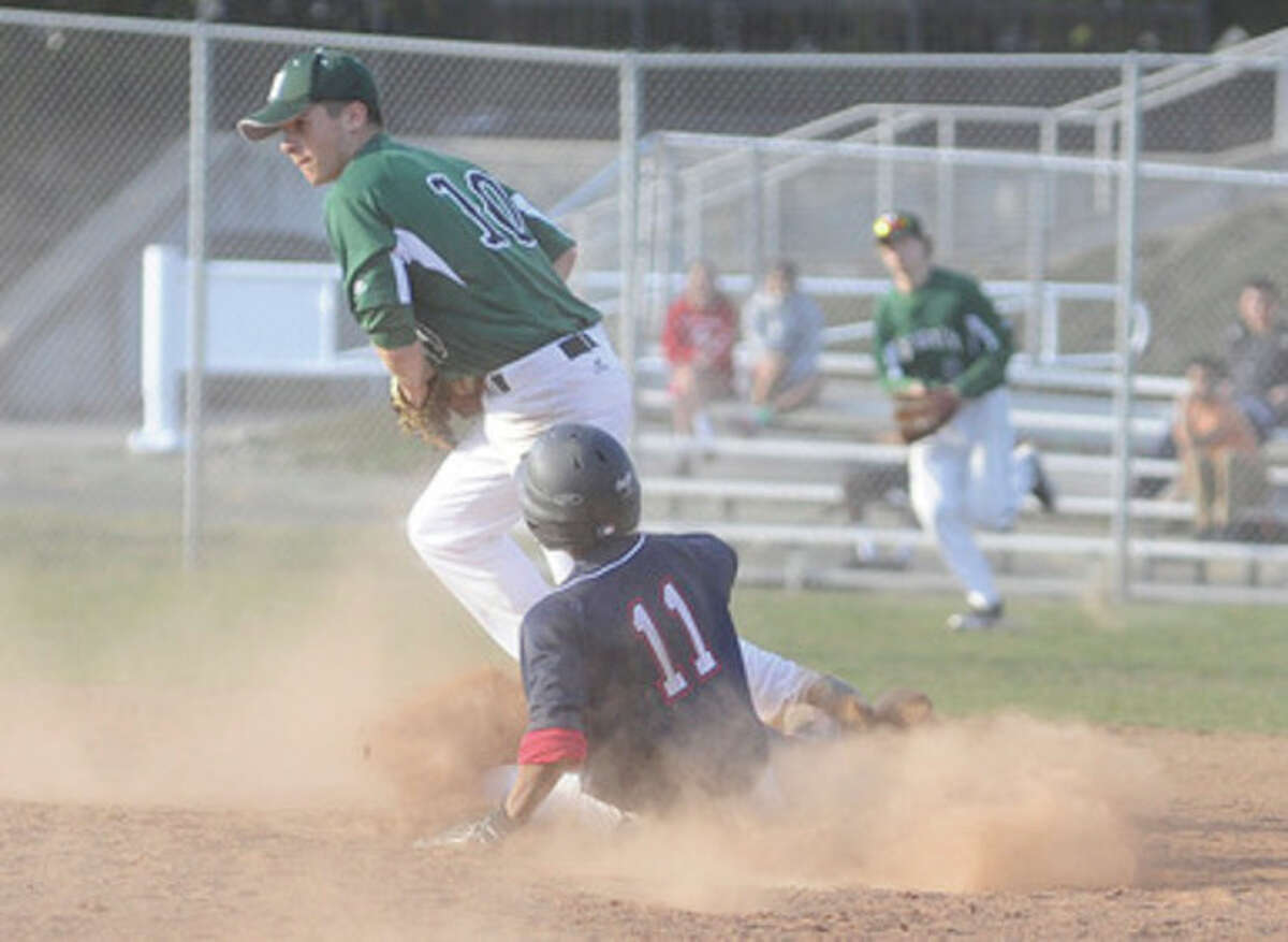 Hour photo/Matthew Vinci Norwalk second baseman Dave Balunek, top, tags the bag to force Edwin Owolo of Brien McMahon at second during Monday's clash of the crosstown rivals at the BMHS diamond. The visiting Bears held on for a 5-4 victory.
