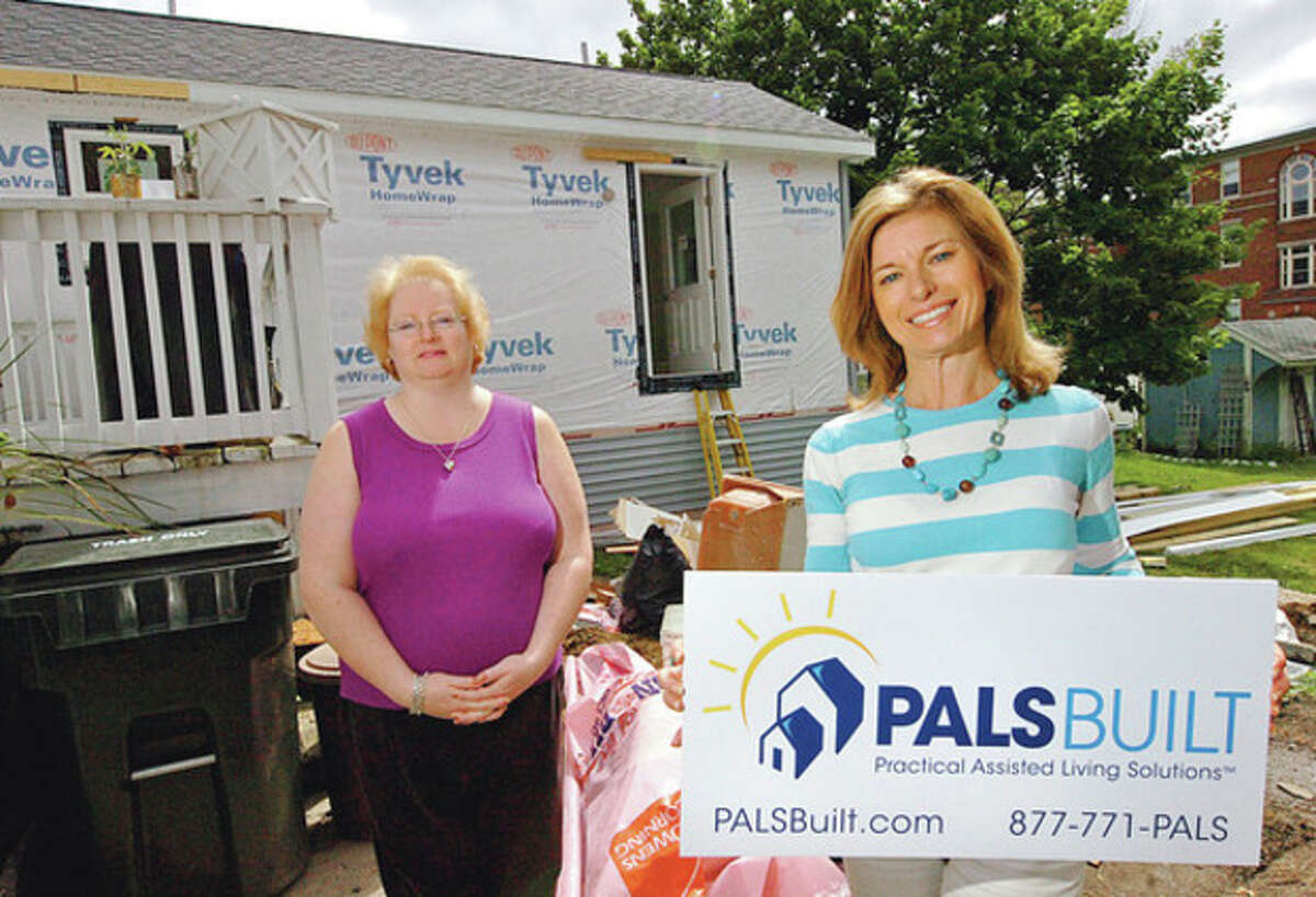 Hour photo / Erik Trautmann Wilton resident Alison Rhodes, right, is the founder of PALS Built and has contracted with Danbury resident Pamela Murphy, left, to add a handicap-accessible modular to her home, so that Murphy can care for her elderly father-in-law.