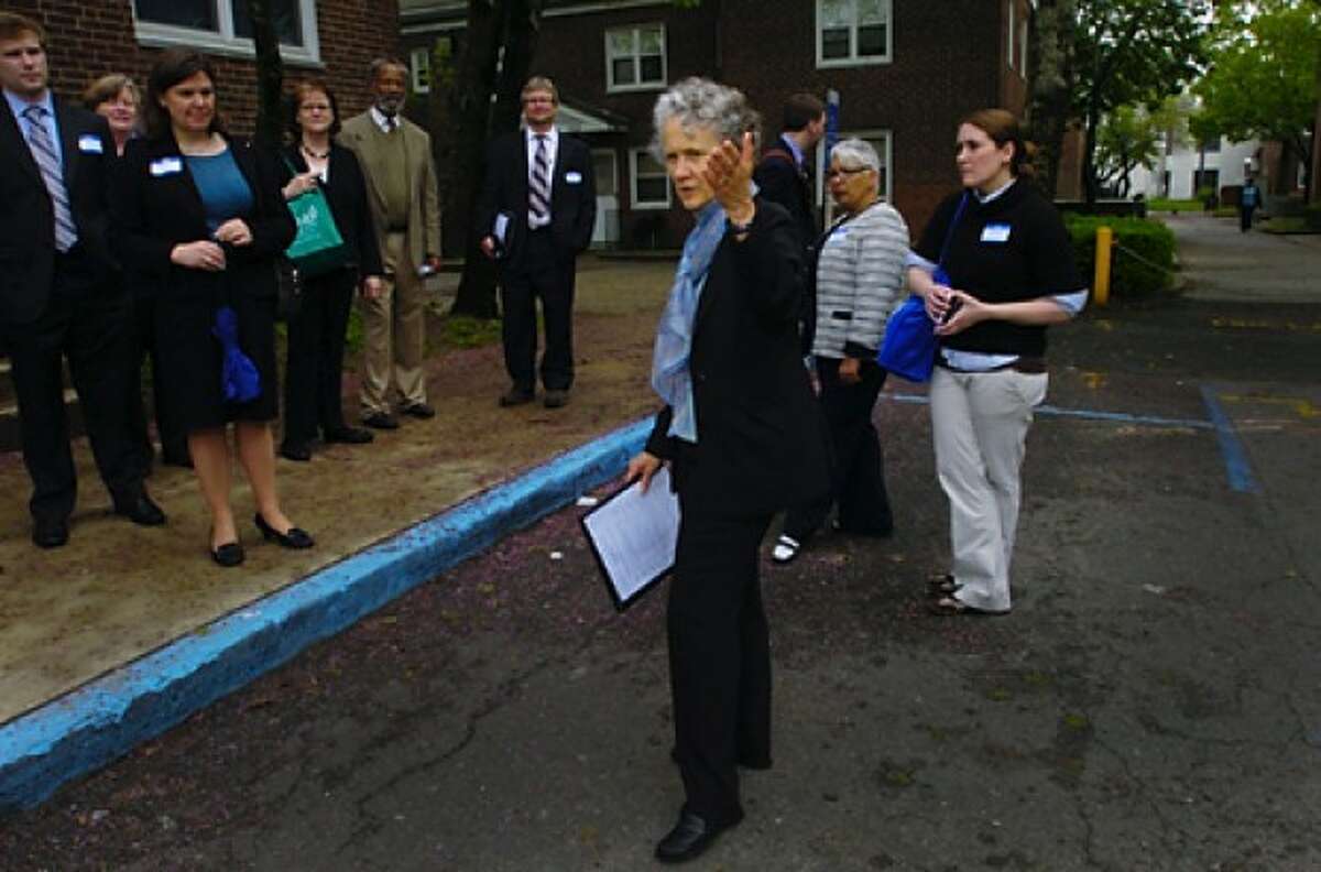 Candace Mayer, Deputy Director for the Norwalk Housing Authority, leads a tour for state and federal HUD officials of the Washington Village public housing complex and the surrounding areas on Thursday afternoon. Hour photo / Erik Trautmann