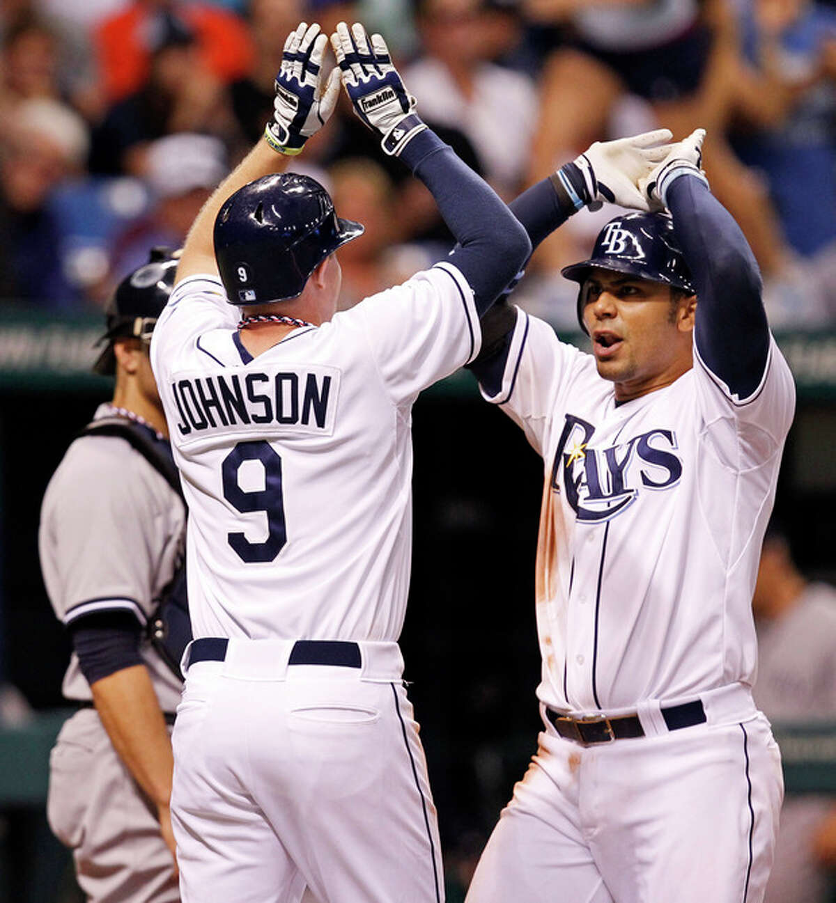 Tampa Bay Rays' Carlos Pena, right, is congratulated by Elliot Johnson after his two-run home run scored both during the seventh inning of a baseball game against the New York Yankees, Wednesday, July 4, 2012, in St. Petersburg, Fla. (AP Photo/Mike Carlson)