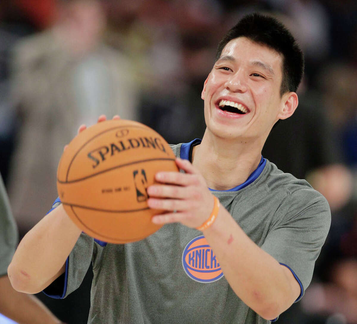 FILE - This Feb. 24, 2012 file photo shows New York Knicks' Jeremy Lin laughing during warmups before the start of the NBA All-Star Rising Stars Challenge basketball game in Orlando, Fla. This would have been such an easy decision in February. Lin was the biggest thing in basketball, and no way the Knicks would have let him go elsewhere. Now, knowing his price and with no assurance he'll play as he did when Linsanity reigned, the Knicks may allow Lin to leave for Houston. (AP Photo/Chris O'Meara, File)