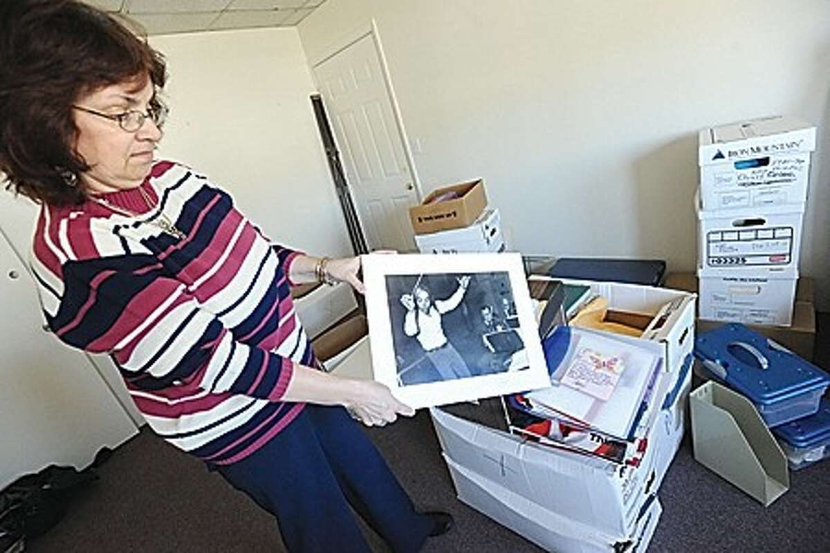 Kate Altman, office manager for the Norwalk Symphony sorts through old symphony photos at the new office location at 83 Wall street in Norwalk. hour photo/matthew vinci
