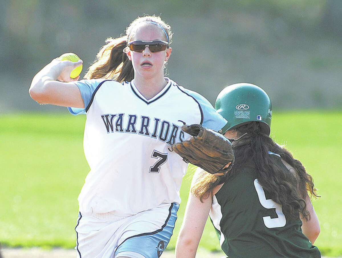 Hour Photo/John Nash - Wilton SS Amy Salvato fires to first after forcing out Norwalk's Patti Sciglimpaglia at second base on a fielder's choice.