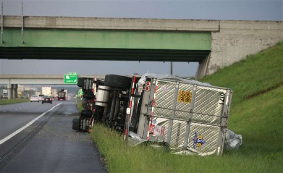 A tractor trailer is tipped over on Interstate 44 near Joplin, Mo., after the town was hit by a tornado on Sunday, May 22, 2011. (AP Photo/The Wichita Eagle, Jaime Green)