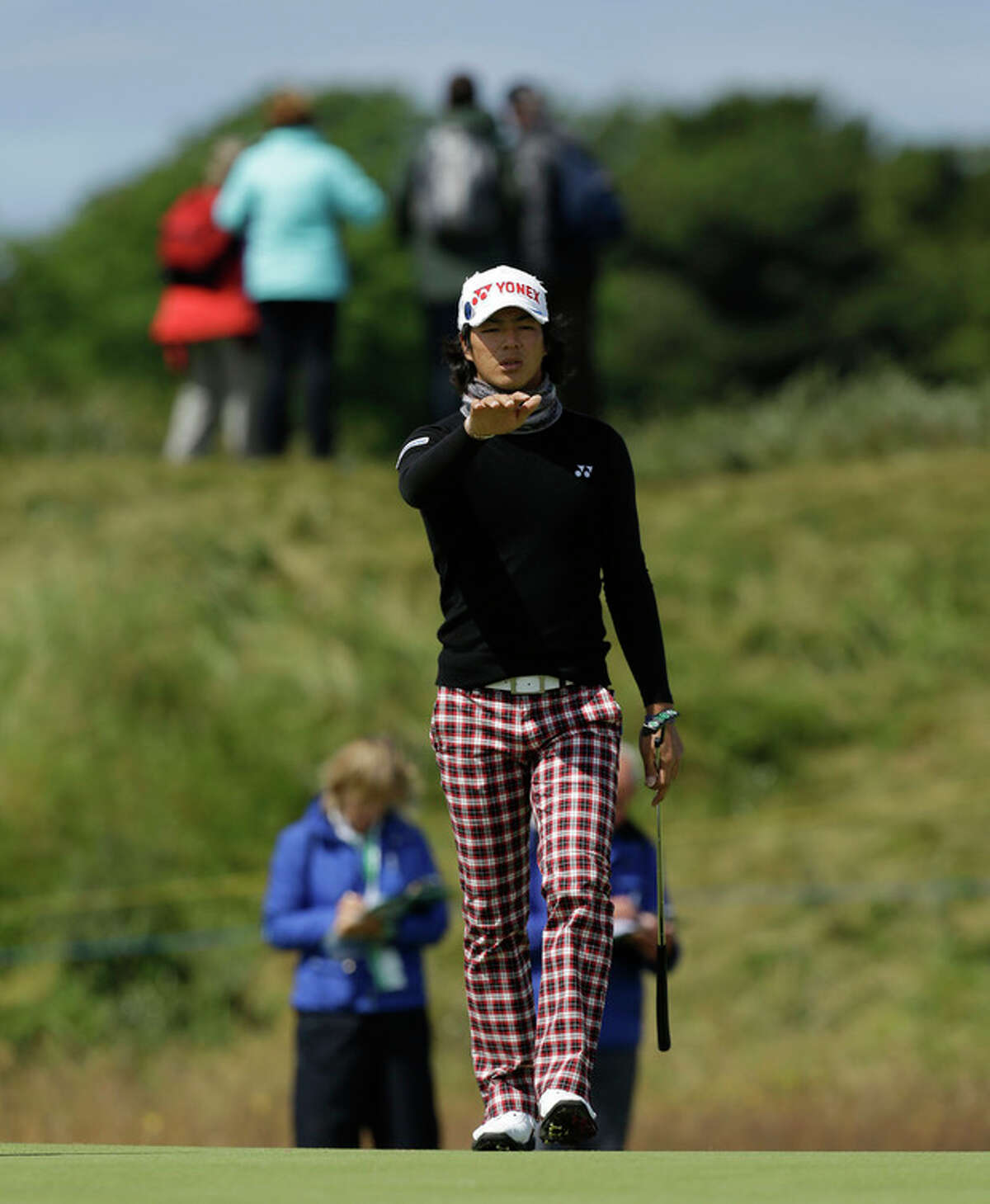 Ryo Ishikawa of Japan reacts after putting on the sixth green during a practice round at Royal Lytham & St Annes golf club ahead of the British Open Golf Championship, Lytham St Annes, England, Wednesday, July 18, 2012. (AP Photo/Jon Super)