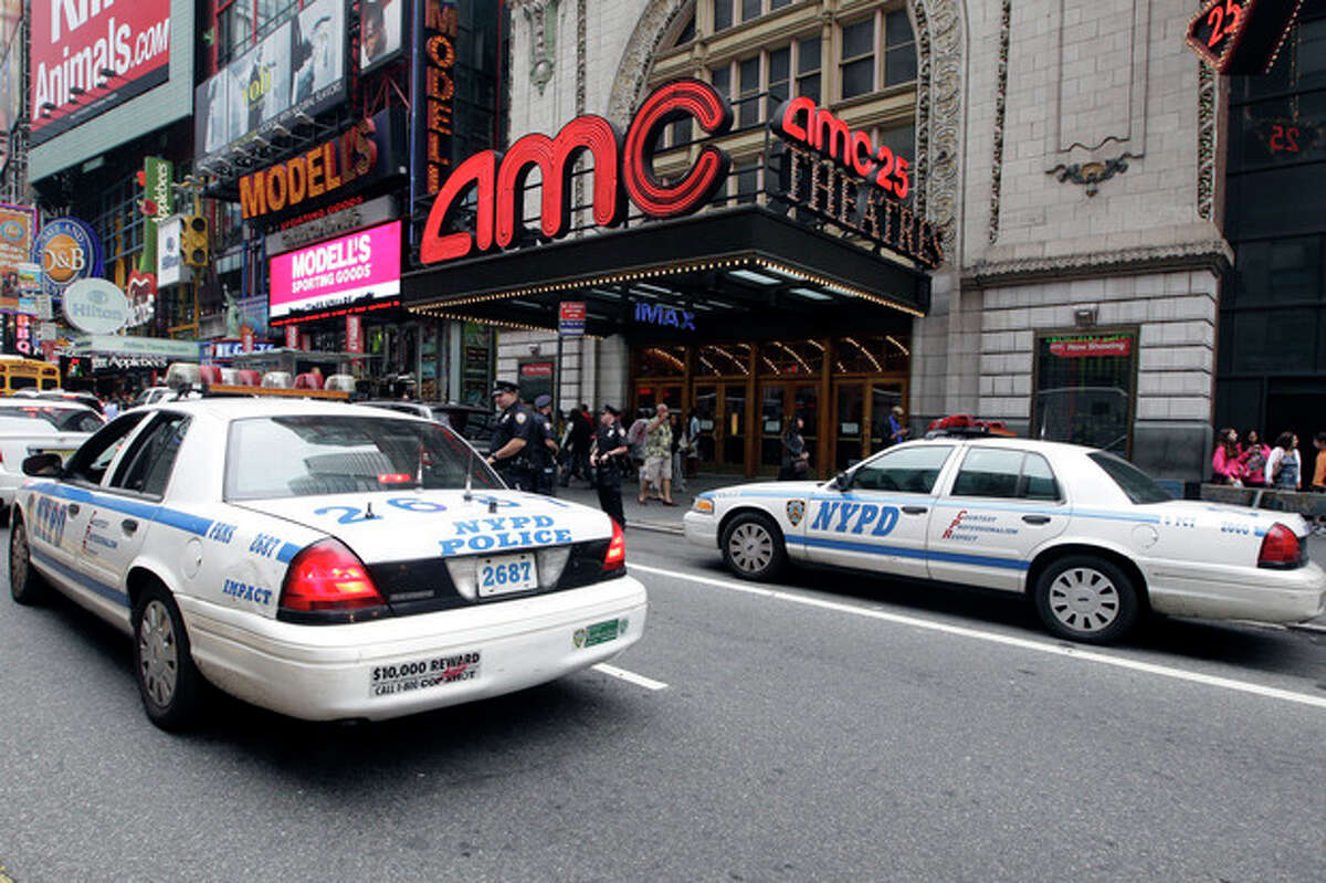 Police officers are seen outside a movie theater screening ?“The Dark Knight Rises,?” Friday, July 20, 2012 in New York. A gunman in a gas mask barged into a crowded Denver-area theater during a midnight premiere of the Batman movie on Friday, hurled a gas canister and then opened fire, killing 12 people and injuring at least 50 others in one of the deadliest mass shootings in recent U.S. history. NYPD commissioner Ray Kelly said the department was providing the extra security at theaters "as a precaution against copycats and to raise the comfort levels among movie patrons." (AP Photo/Mary Altaffer)