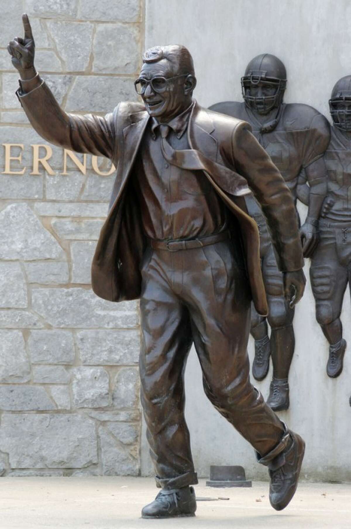 FILE - A statue of former Penn State University head football coach Joe Paterno stands outside Beaver Stadium on in this July 12, 2012 file photo. Police and construction workers have barricaded both sides of street and the sidewalks near the Joe Paterno statue at Penn State University. A chain-link fence has been erected around the perimeter surrounding the statue. (AP Photo/Gene J. Puskar, File)