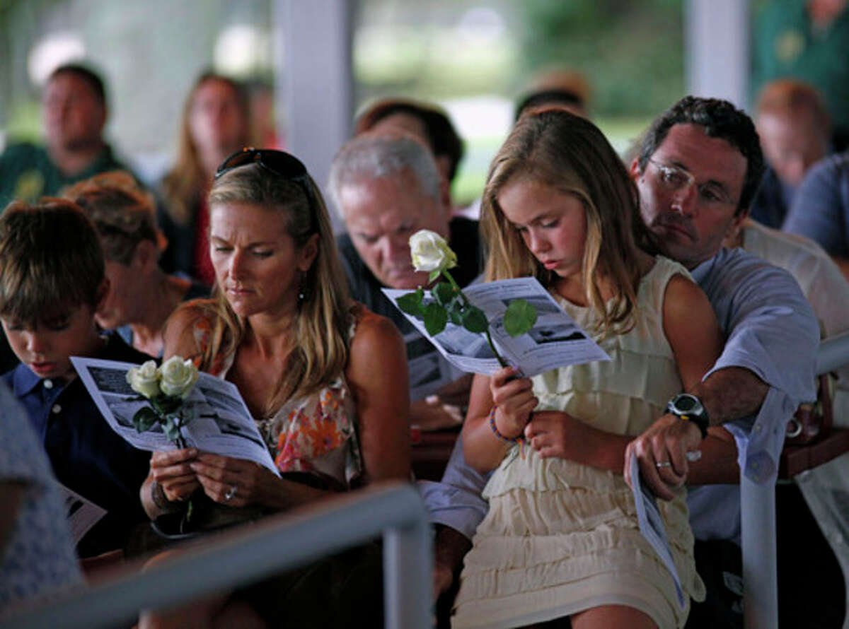 A family looks on as victim's names are read during the Connecticut Remembers Steptember 11th Memorial Service held at Sherwood Island State Park Thursday evening.