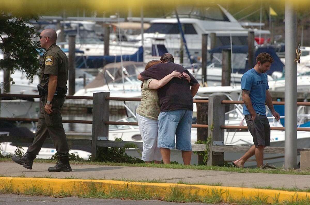 Hour Photo/ Alex von Kleydorff. Family and freinds gather Monday morning at Stamfords Czescik Municipal Marina to wait for information on a search for the missing NY firefighter, lost after his boat crashed Sunday night in Stamford harbor