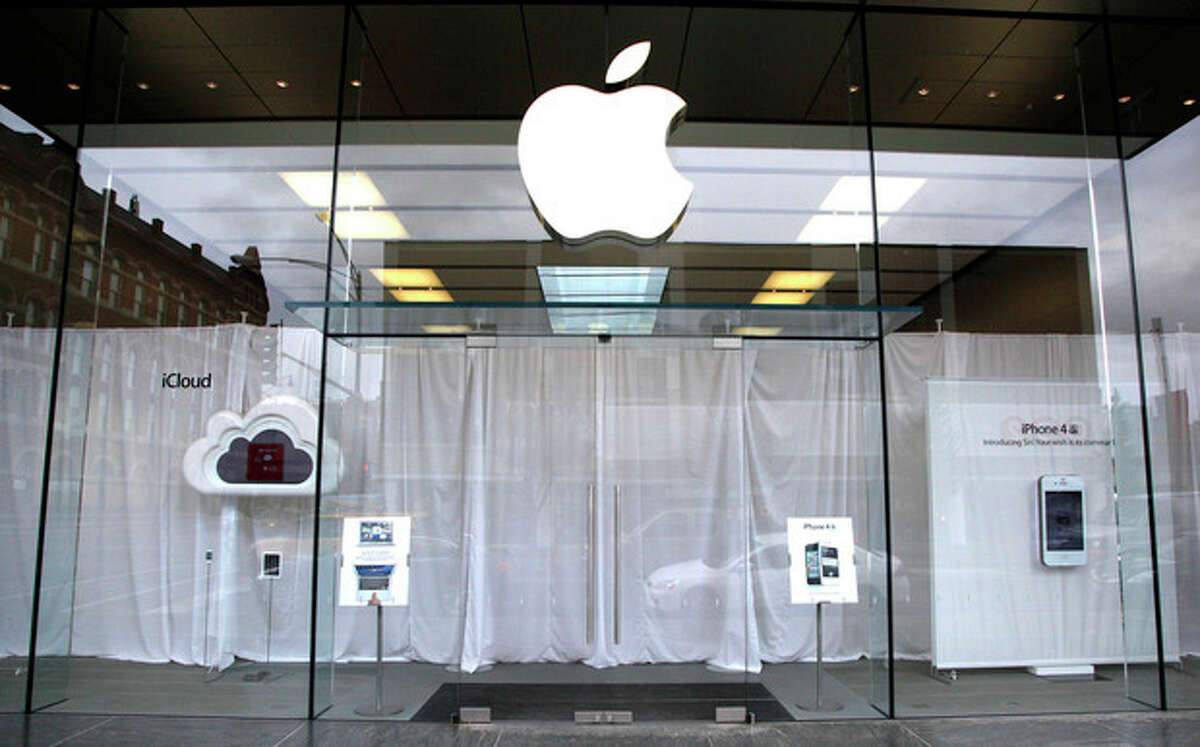 White curtains hang as employees inside the Lincoln Park Apple store in Chicago, gather to watch a video feed from the California memorial service for founder Steve Jobs Wednesday, Oct. 19, 2011. (AP Photo/Charles Rex Arbogast)