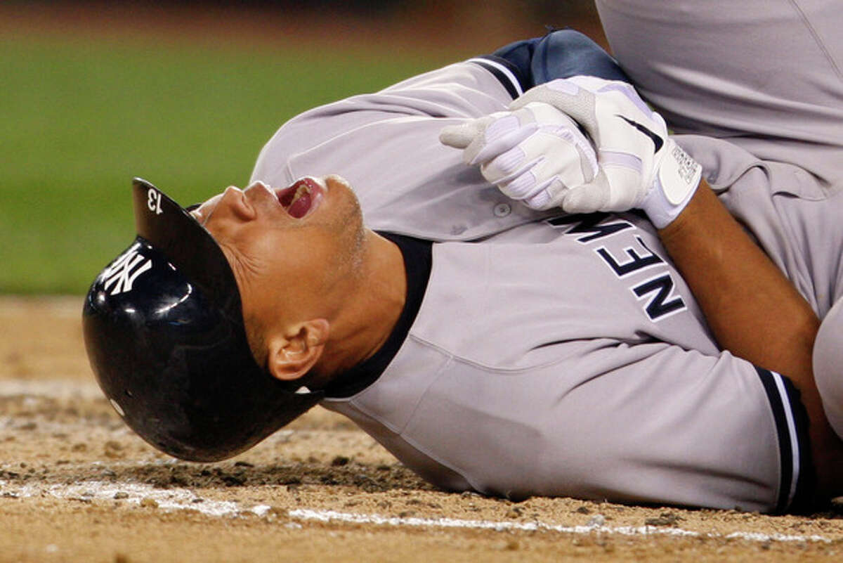New York Yankees' Alex Rodriguez rolls on the ground after being hit by a pitch in the eighth inning of a baseball game against the Seattle Mariners, Tuesday, July 24, 2012, in Seattle. Even as Rodriguez writhed on the ground in pain, he didn't believe his left hand was fractured. Turns out A-Rod was wrong, and now the Yankees will be without another of their star players. (AP Photo/Kevin P. Casey)