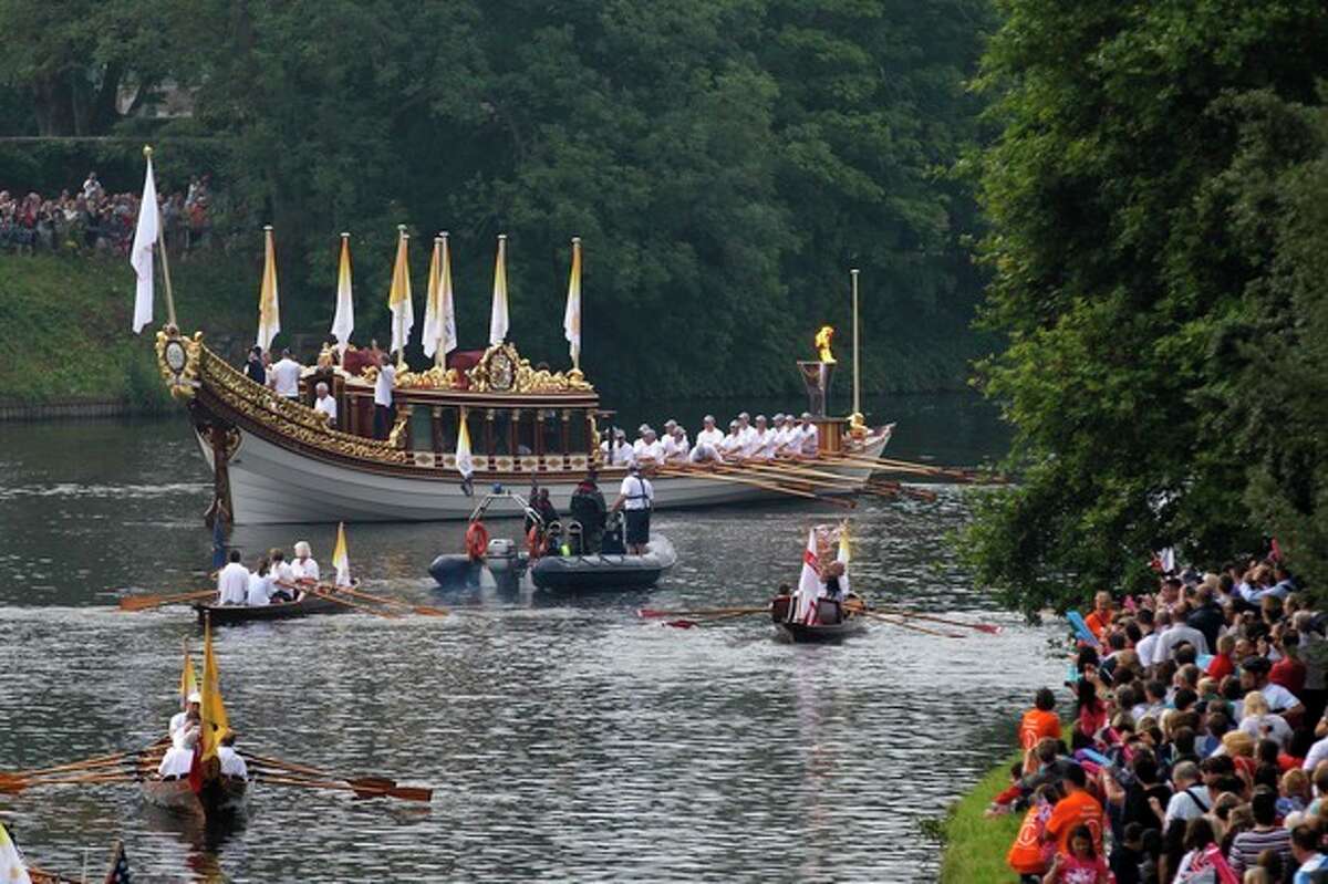 The royal barge Gloriana carries the Olympic flame in a cauldron on board, as it leaves Hampton Court Palace in London, as it makes its way along the river Thames into central London on the final day of the Torch Relay, Friday, July 27, 2012. (AP Photo/Sang Tan)