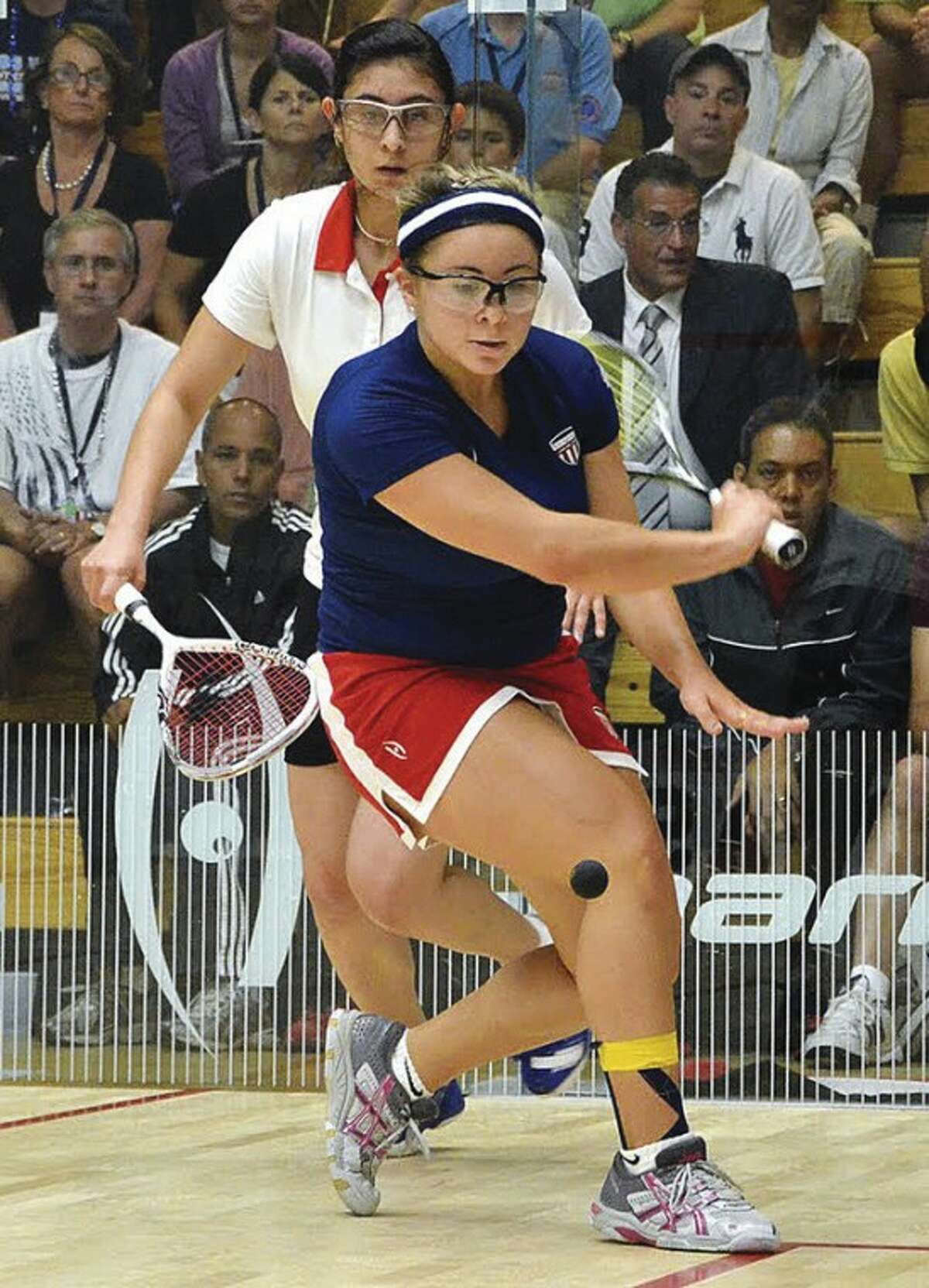 @White=[C] Photo by Steve Cubbins/Courtesy of squash.uk.co Olivia Blatchford, right, of Wilton goes up against her Egyptian opponent during the World Junior Squash Championships in Boston last month. Blatchford helped lead her team to a second-place finish, its best-ever showing, before turning pro.