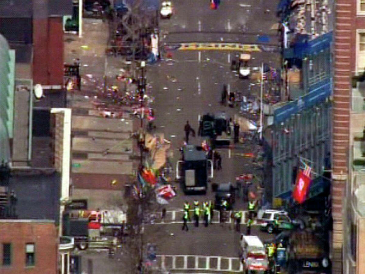 Medical workers and authorities work on the scene near the finish line of the 2013 Boston Marathon following an explosion in Boston, Monday, April 15, 2013. (AP Photo/WCVB-TV/ABC) MANDATORY CREDIT