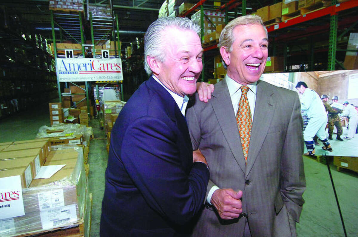 AmeriCares President Curt Welling gives Bobby Valentine a well done for their successful relief effort undetaken for japanese Earthquake and Tsunami survivors.