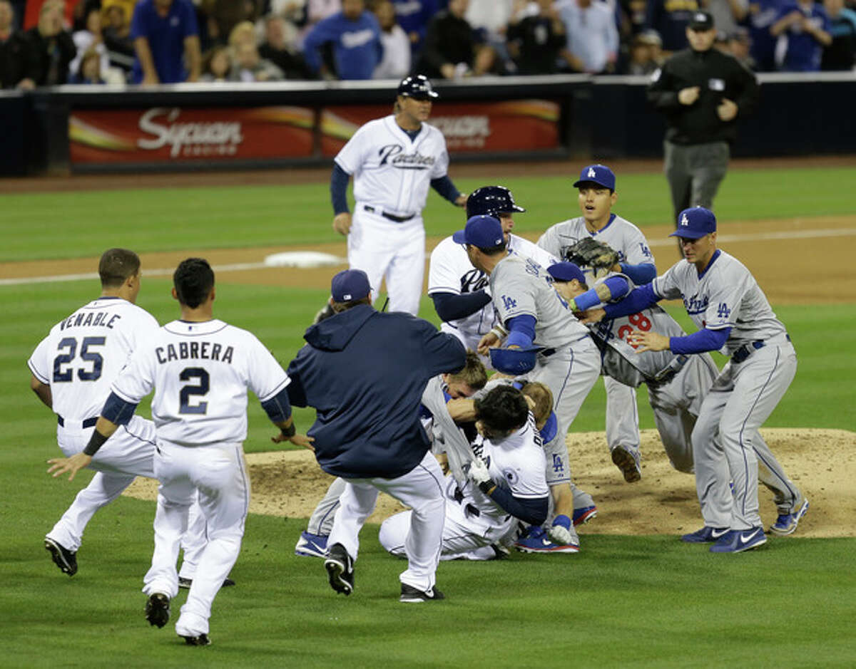 San Diego Padres' Carlos Quentin and teammates battle the Los Angeles Dodgers after Quentin was hit by a pitch thrown by Dodgers pitcher Zack Greinke in the sixth inning of baseball game in San Diego, Thursday, April 11, 2013. (AP Photo/Lenny Ignelzi)