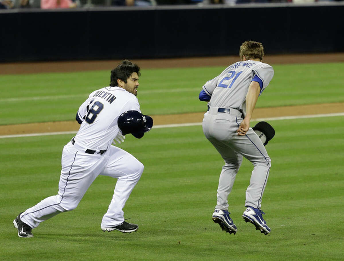 San Diego Padres' Carlos Quentin charges into Los Angeles Dodgers pitcher Zack Greinke after being hit by a pitch in the sixth inning of baseball game in San Diego, Thursday, April 11, 2013. (AP Photo/Lenny Ignelzi)
