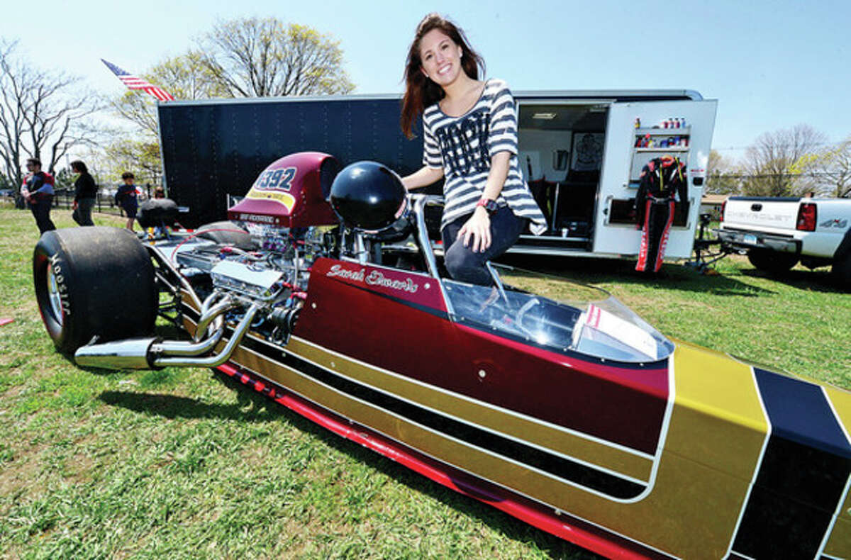 Hour photo / Erik Trautmann Drag car racer and Norwalk Community Collge student Sarah Edwards was on hand at the Exchange Club's Antique Auto Show where 500 to 600 cars were exhibited at Taylor Farm in Norwalk Sunday. The cars ages range from pre 1915 to 1972.