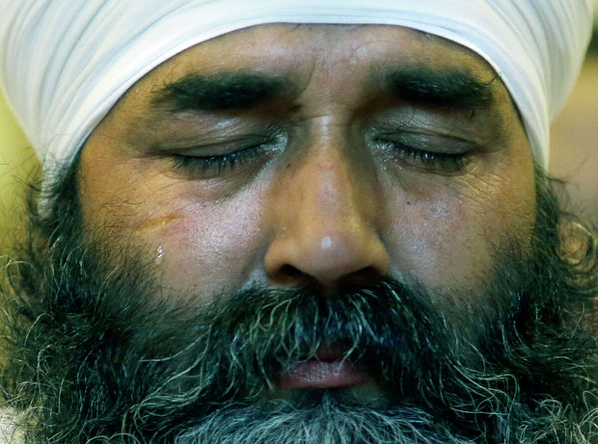 A tear runs down the cheek of a member of the Sikh Temple of Wisconsin as he attends a news conference at Oak Creek Centennial church in Oak Creek, Wis. on Monday, Aug 6, 2012. Officials and witnesses said a gunman walked into the temple on Sunday, Aug. 5, 2012 and opened fire as several dozen people prepared for Sunday morning services. Six were killed, and three were critically wounded. (AP Photo/Jeffrey Phelps)