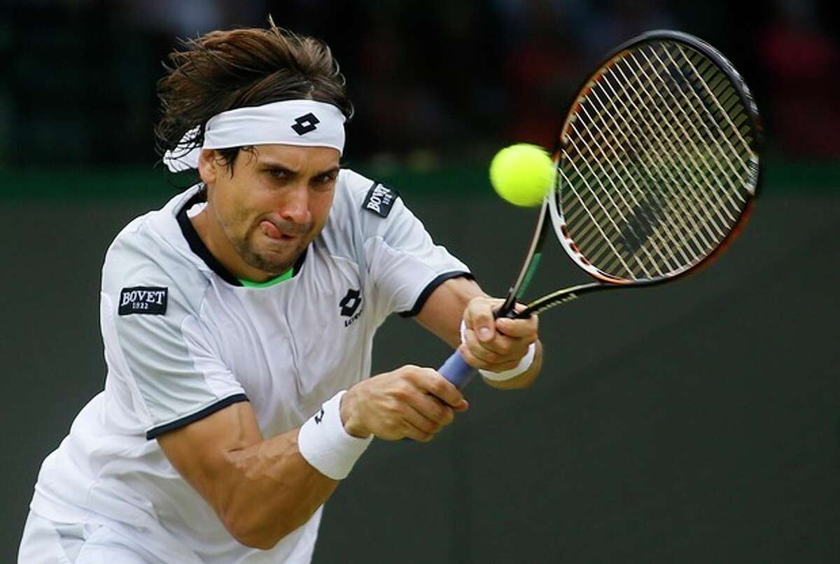 David Ferrer of Spain plays a return to Roberto Bautista Agut of Spain in their Men's second round singles match at the All England Lawn Tennis Championships in Wimbledon, London, Friday, June 28, 2013. (AP Photo/Kirsty Wigglesworth)