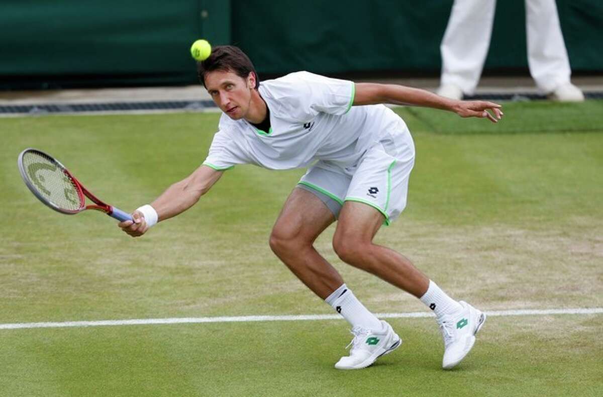 Sergiy Stakhovsky of Ukraine plays a return to Jurgen Melzer of Austria during their Men's second round singles match at the All England Lawn Tennis Championships in Wimbledon, London, Friday, June 28, 2013. (AP Photo/Sang Tan)