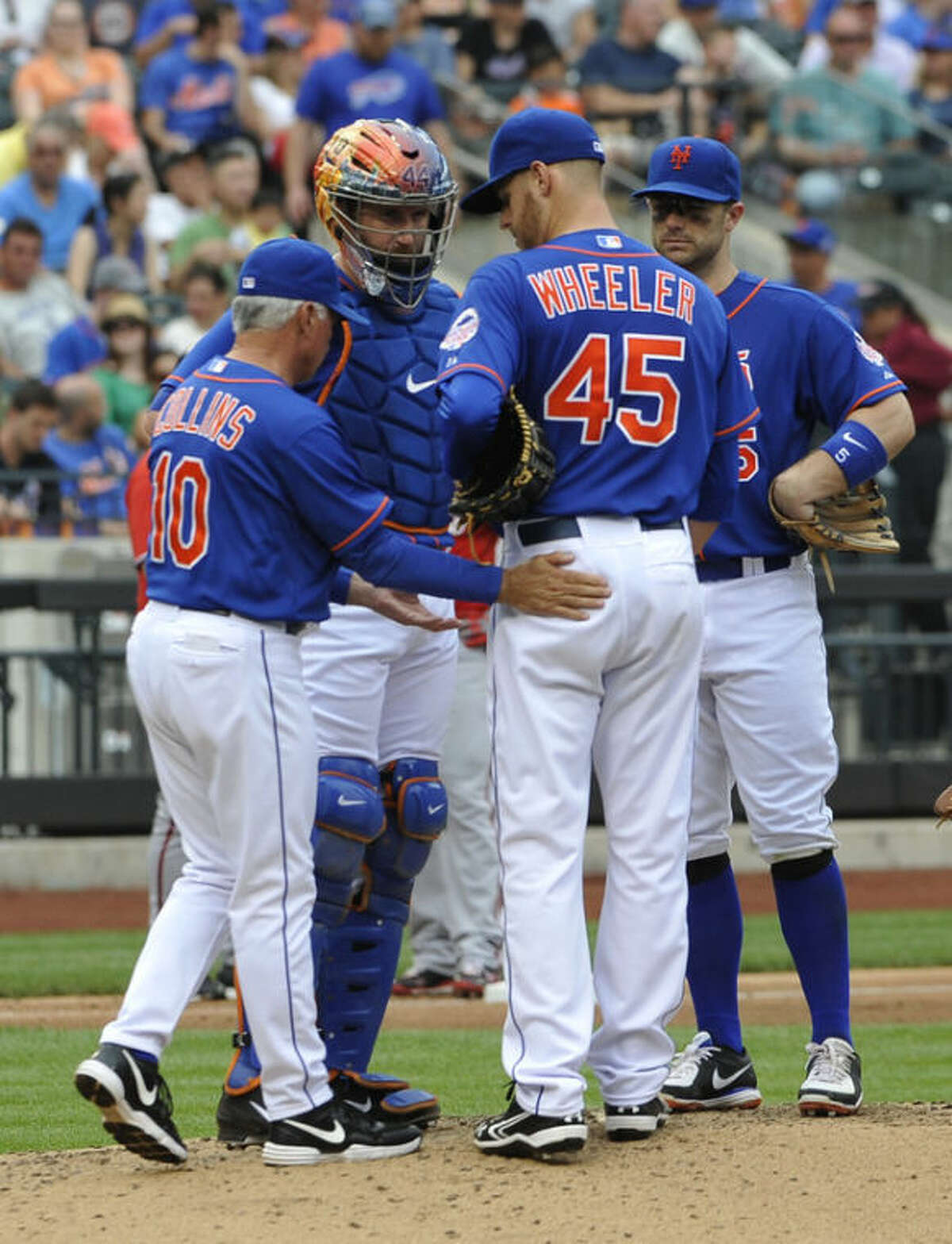 New York Mets York catcher John Buck and David Wright watch as manager Terry Collins (10) takes starting pitcher Zack Wheeler (45) out of the baseball game against the Washington Nationals' in the fifth inning at Citi Field on Sunday, June 30, 2013 in New (AP Photo/Kathy Kmonicek)