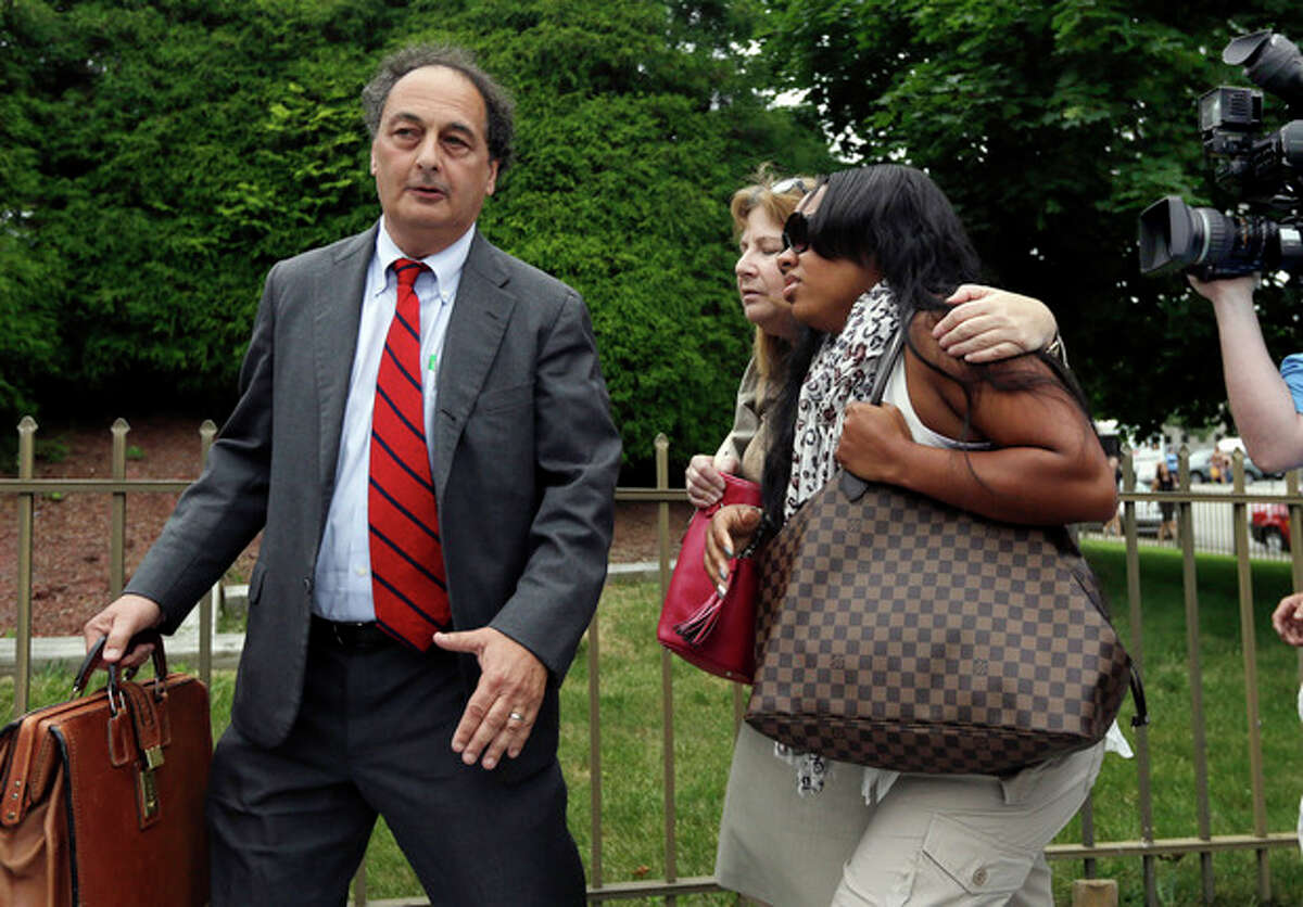 Shayanna Jenkins, right, fiancee of former New England Patriots football player Aaron Hernandez, is escorted by attorneys Janice Bassil and James Sultan, left, after a bail hearing in Fall River Superior Court Thursday, June 27, 2013, in Fall River, Mass. Hernandez, charged with murdering Odin Lloyd, a 27-year-old semi-pro football player, was denied bail. (AP Photo/Elise Amendola)