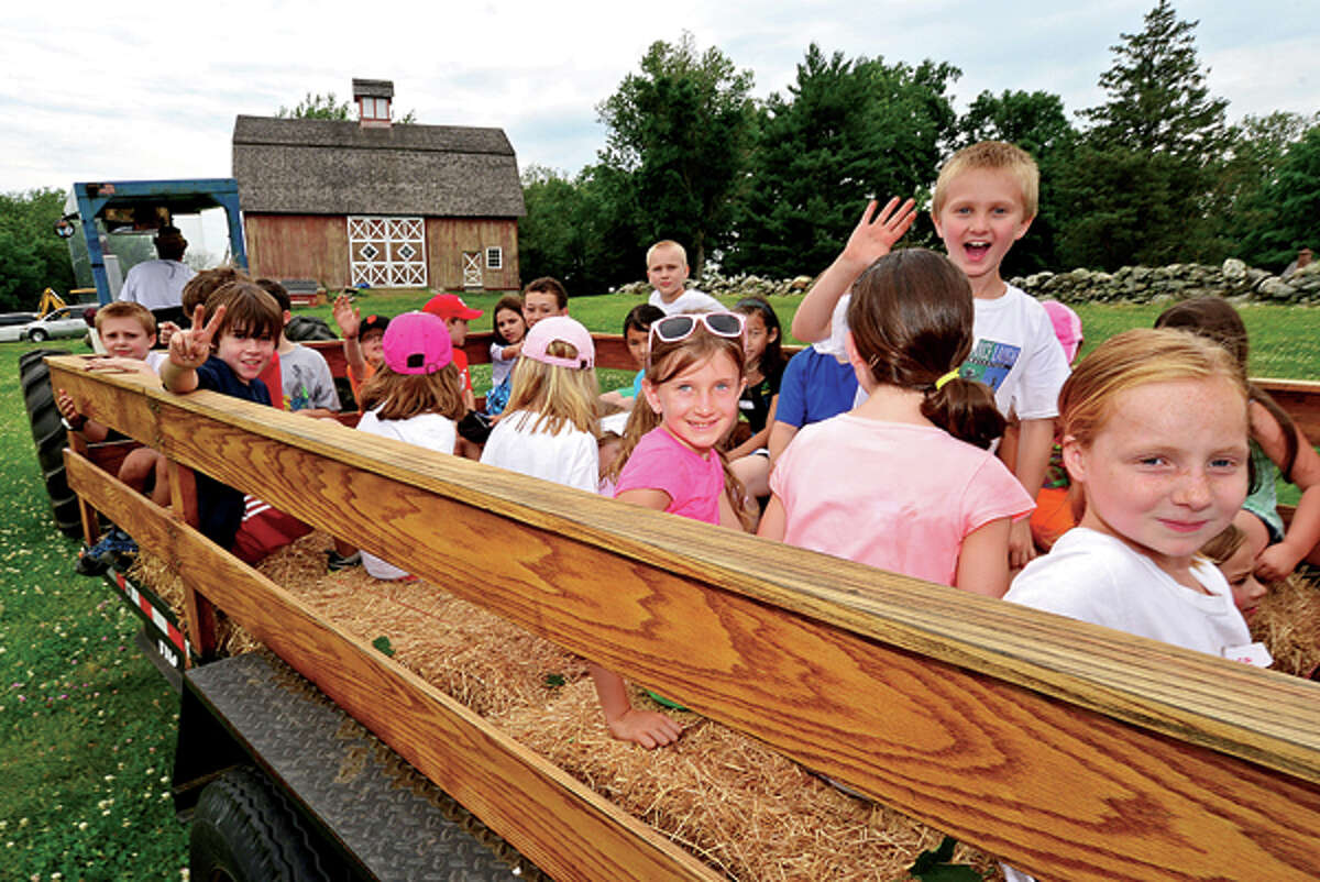 Campers enjoy a hayride as Ambler Farm begins its summer programs for preschoolers and students grades 1-7 this week through July. The programs introduce children to animals on the farm, harvesting, woodworking and planting. Hour photo / Erik Trautmann