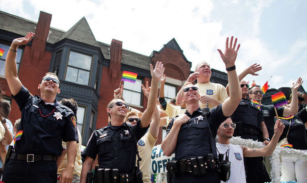 Members of the Chicago Lesbian and Gay Police Association wave to crowds during the Chicago Gay Pride Parade in Chicago, Sunday, June 30, 2013. (AP Photo/Scott Eisen)