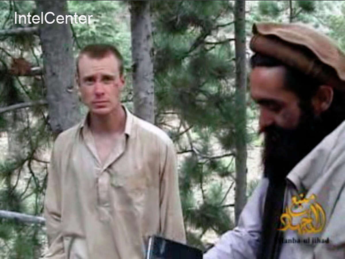 FILE - This file image provided by IntelCenter on Wednesday Dec. 8, 2010 shows a frame grab from a video released by the Taliban containing footage of a man believed to be Bowe Bergdahl, left. A Taliban spokesman, Shaheen Suhail, in an exclusive telephone interview with The Associated Press from the newly opened Taliban offices in Doha, Qatar, said Thursday, June 20, 2013, that they are ready to hand over U.S. soldier Pfc. Bowe R. Bergdahl held captive since 2009 in exchange for five of their senior operatives being held at the Guantanamo Bay prison. The U.S. is scrambling to save talks with the Taliban after angry complaints from Afghanistan President Hamid Karzai. (AP Photo/IntelCenter, File) MANDATORY CREDIT: INTELCENTER; NO SALES; EDS NOTE: "INTELCENTER" AT LEFT TOP CORNER ADDED BY SOURCE