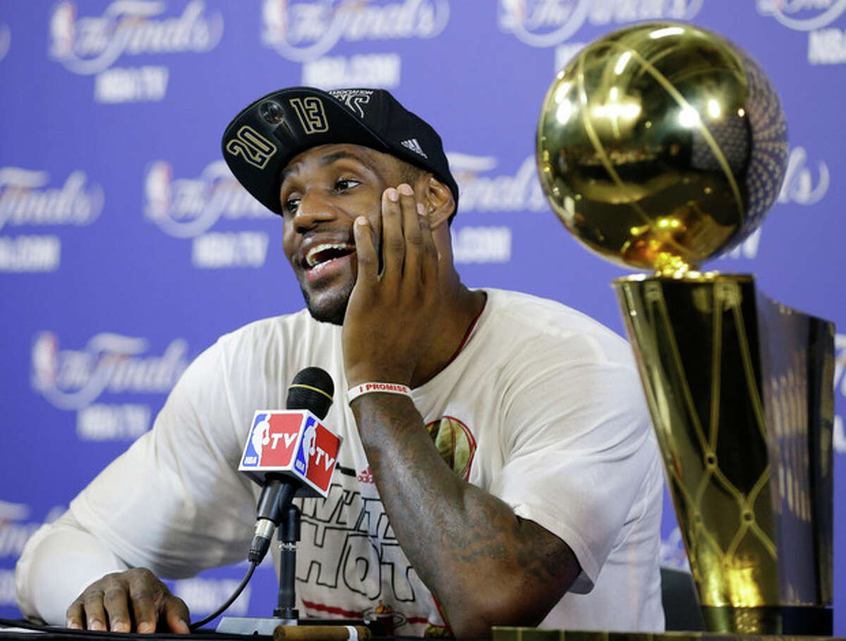 The Miami Heat's LeBron James smiles during a post game news conference following Game 7 of the NBA basketball championship game against the San Antonio Spurs, Friday, June 21, 2013, in Miami. The Miami Heat defeated the San Antonio Spurs 95-88 to win their second straight NBA championship. (AP Photo/Lynne Sladky)