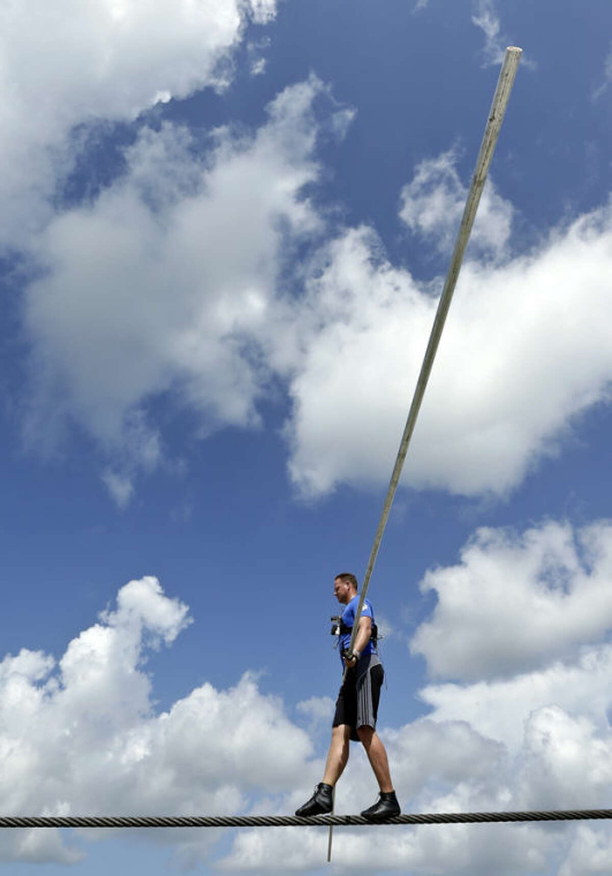 High wire performer Nik Wallenda walks across a wire as he practices Tuesday, June 18, 2013 in Sarasota, Fla. Wallenda, a seventh generation high-wire walker, will attempt to walk across the Grand Canyon on Sunday, June 23, 2013. (AP Photo/Chris O'Meara)