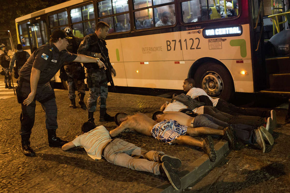 A group of protestors lie on the ground lay on the ground before being searched by police during an anti-government demonstration in Rio de Janeiro, Brazil, Thursday, June 20, 2013. More than half a million Brazilians poured into the streets of at least 80 Brazilian cities Thursday in demonstrations that saw violent clashes and renewed calls for an end to government corruption and demands for better public services. Riot police battled protesters in at least five cities, with some of the most intense clashes happening in Rio de Janeiro, where an estimated 300,000 demonstrators swarmed into the seaside city's central area.(AP Photo/Felipe Dana)