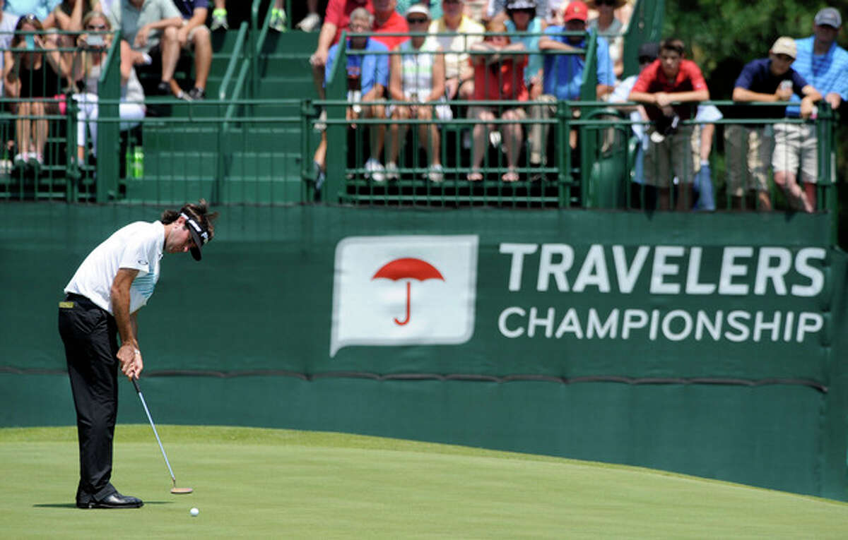 Bubba Watson watches his putt on the eighth green during the second round of the Travelers Championship golf tournament in Cromwell, Conn., Friday, June 21, 2013. Watson shot a 3-under par 67 in his round, to go 10-under par for the tournament. (AP Photo/Fred Beckham)