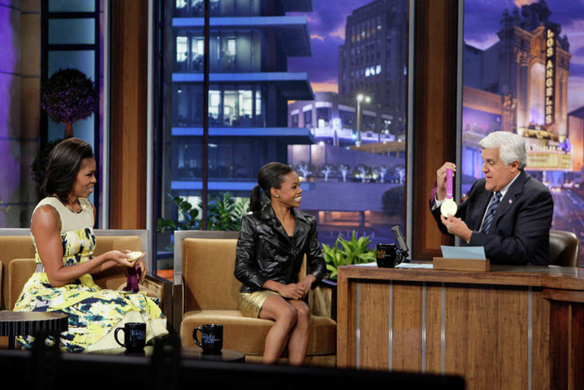 This Monday, Aug. 13, 2012 photo released by NBC shows first lady Michelle Obama, left, olympic gold medalist Gabby Douglas and host Jay Leno during a taping of "The Tonight Show with Jay Leno," in Burbank, Calif. (AP Photo/NBC, Margaret Norton)