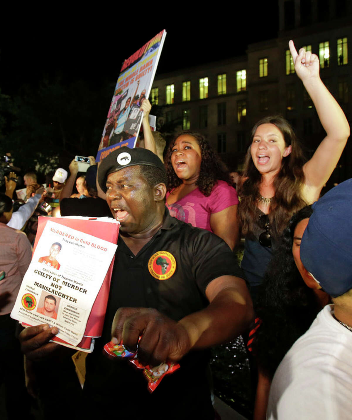 James Evan Muhammad, front left, of the New Black Panther Party, shouts slogans after the verdict of not guilty was handed down in the trial of George Zimmerman at the Seminole County Courthouse, Saturday, July 13, 2013, in Sanford, Fla. Neighborhood watch captain George Zimmerman was cleared of all charges Saturday in the shooting of Trayvon Martin, the unarmed black teenager whose killing unleashed furious debate across the U.S. over racial profiling, self-defense and equal justice. (AP Photo/John Raoux)