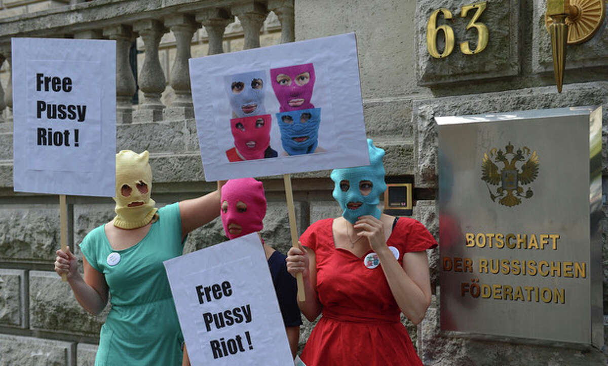 Masked female activists demonstrate in support of members of the feminist punk group Pussy Riot in front of the Russian Embassy in Berlin, Germany, Thursday Aug. 9, 2012. Prosecutors in Russia on Tuesday called for three-year prison sentences for feminist punk rockers who gave an impromptu performance in Moscow's main cathedral to call for an end to Vladimir Putin's rule, in a case that has caused international outrage and split Russian society. (AP Photo/dapd/Oliver Lang)