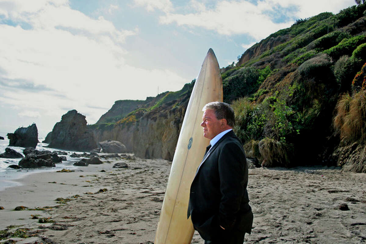 This image released by Priceline.com shows William Shatner on a beach during a commercial for Priceline.com. Seven months after a commercial showed Shatner, as the Negotiator, plunging off a cliff and into apparent oblivion, the company is resurrecting him in a new 30-second TV and online spot set to debut Thursday, Aug. 16. (AP Photo/Priceline.com, Susan Smith)