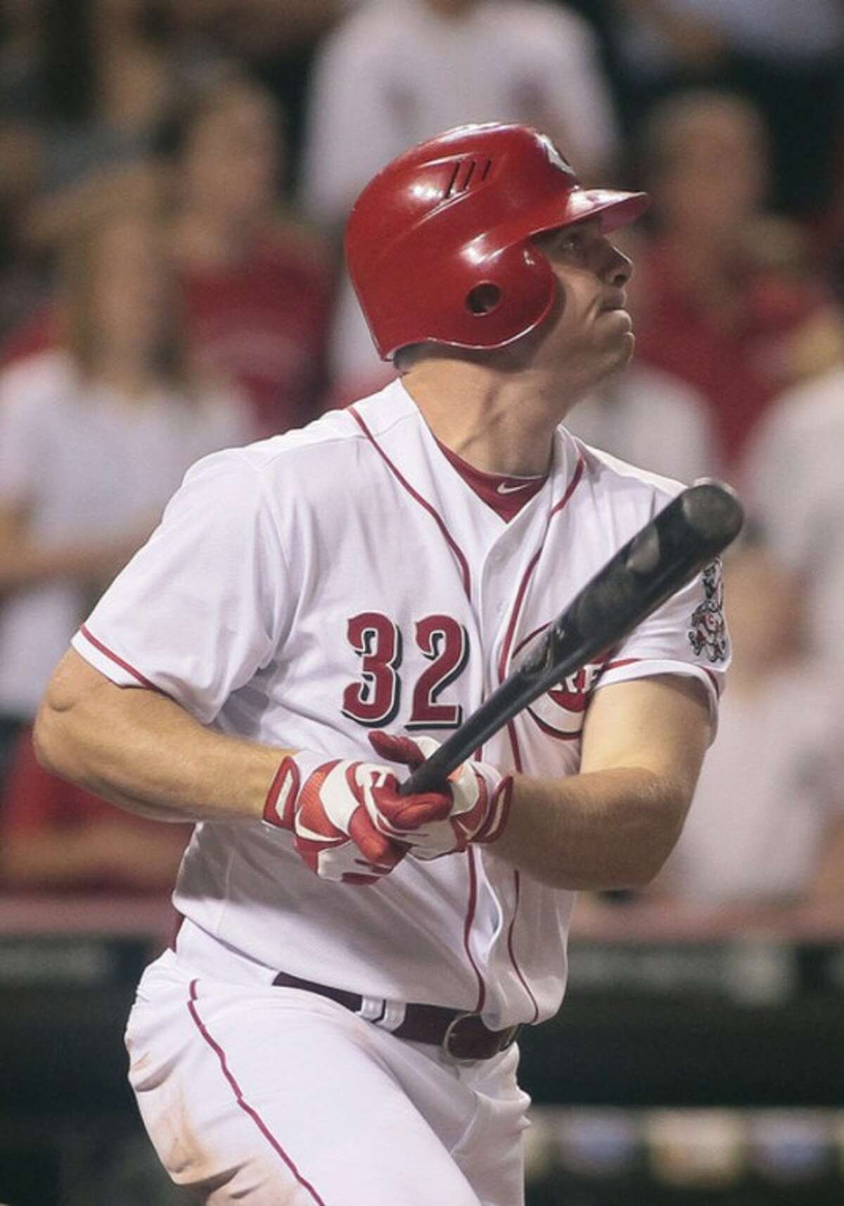 Cincinnati Reds' Jay Bruce watches his three-run home run off of New York Mets reliever Josh Edgin scoring Brandon Phillips and Ryan Ludwig in the ninth inning of a baseball game, Tuesday, Aug. 14, 2012, in Cincinnati. The Red won 3-0. (AP Photo/Tony Tribble)