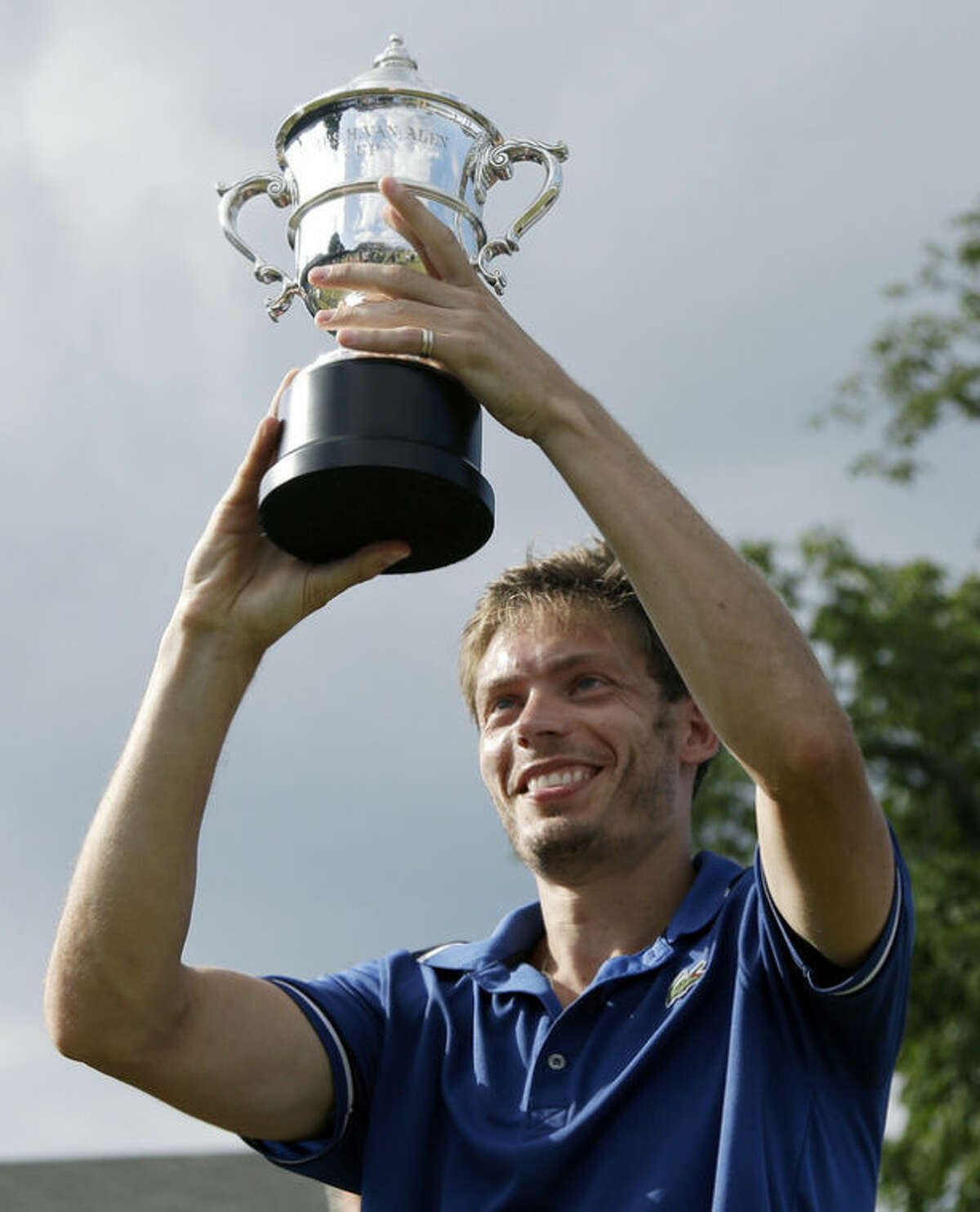 Nicolas Mahut, of France, hoists the Van Alen Cup after defeating Lleyton Hewitt, of Australia, in the finals of the Hall of Fame Tennis Championships in Newport, R.I. Sunday, July 14, 2013. Mahut won 5-7, 7-5, 6-3. (AP Photo/Elise Amendola)