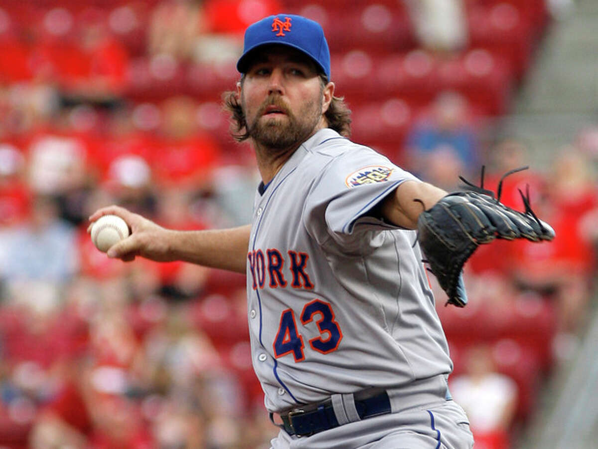 New York Mets starting pitcher R.A. Dickey throws against the Cincinnati Reds in the first inning during a baseball game, Wednesday, Aug. 15, 2012, in Cincinnati. (AP Photo/David Kohl)