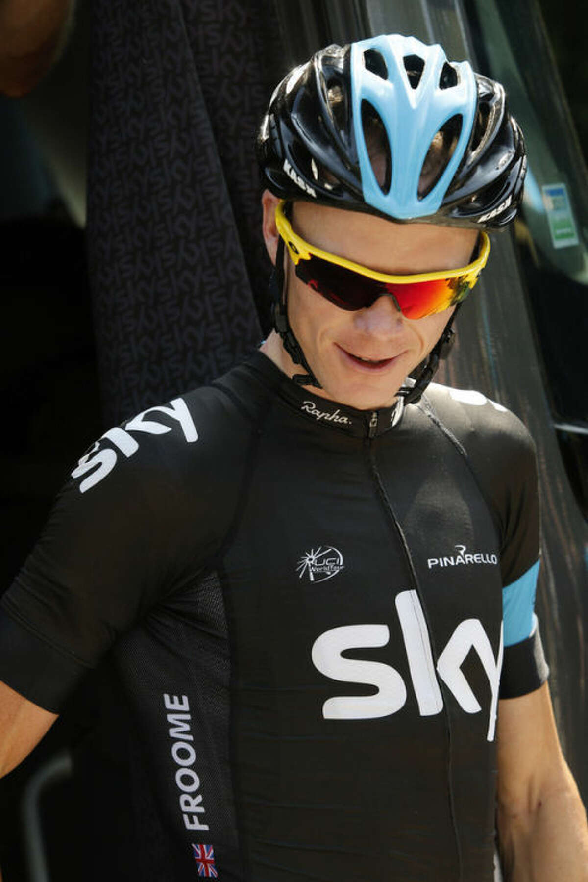 Overall leader Christopher Froome of Britain leaves the team bus for a training on the rest day of the Tour de France cycling race in Orange, southern France, Monday July 15, 2013. (AP Photo/Laurent Cipriani)