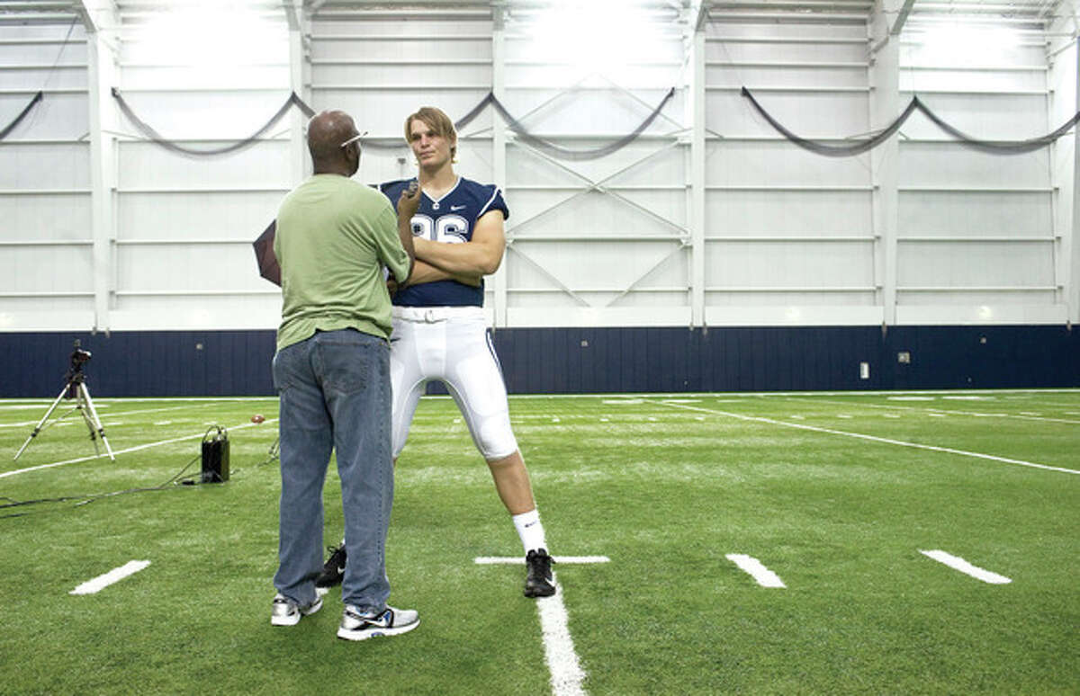 Connecticut's Andreas Knappe, right, of Denmark, is interviewed during an NCAA college football media day in Storrs, Conn., Friday, Aug. 10, 2012. (AP Photo/Jessica Hill)
