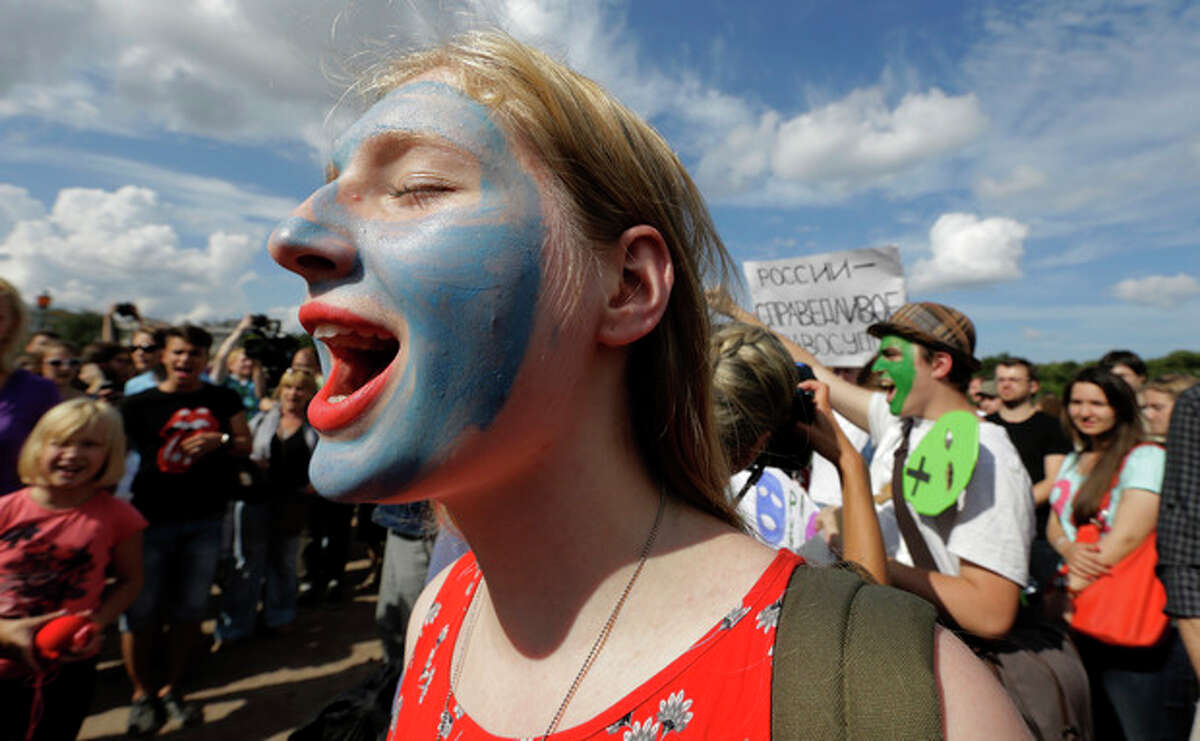 Demonstrators with painted faces chant slogans in support of the Russian punk group Pussy Riot whose members face prison for a stunt against President Vladimir Putin, in St.Petersburg, Russia, Friday, Aug. 17, 2012. Pussy Riot members, two of whom have young children, are charged with hooliganism connected to religious hatred, but the case is widely seen as a warning that authorities will only tolerate opposition under tightly controlled conditions. (AP Photo/Dmitry Lovetsky)