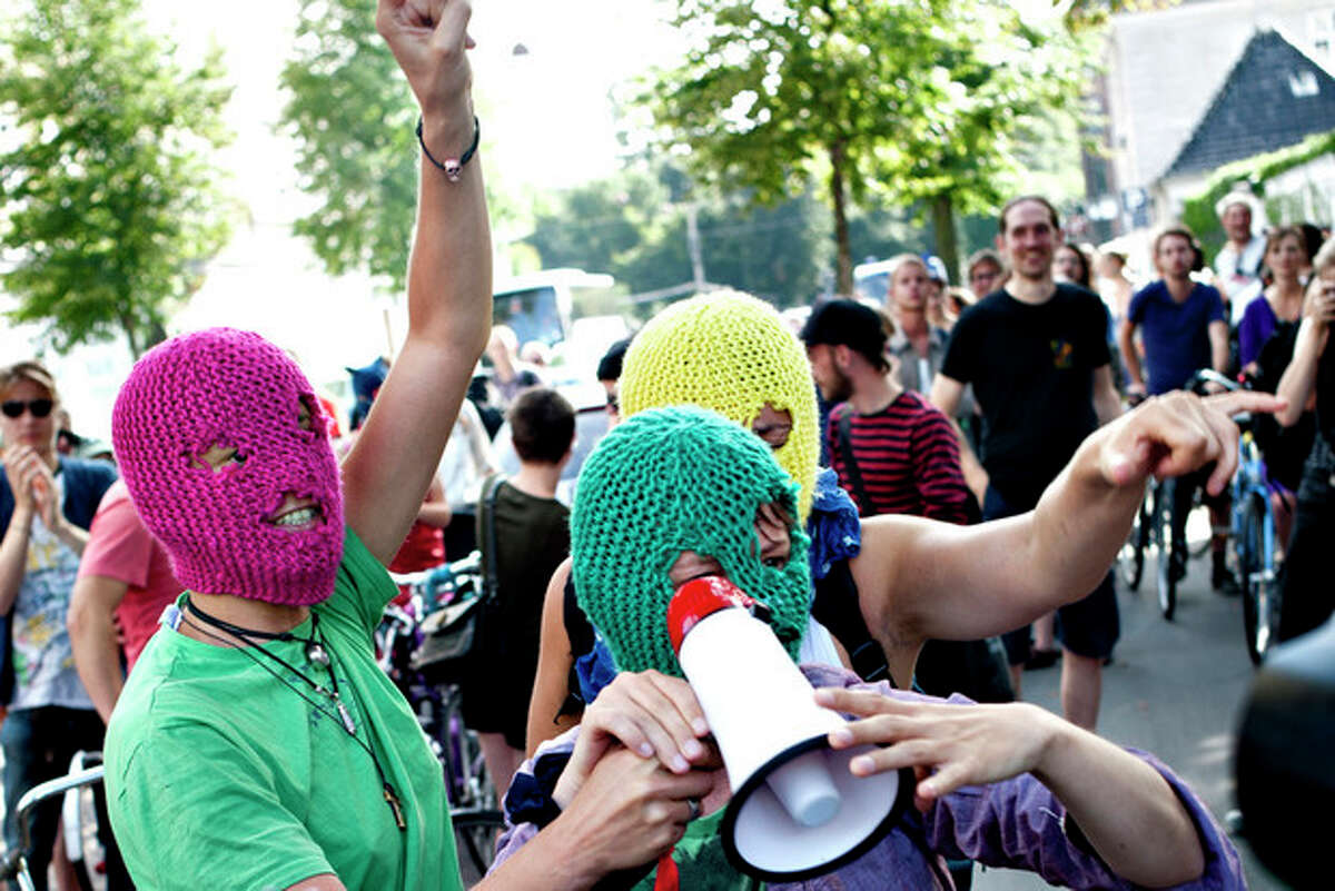Demonstrators talk on a megaphone in support of the Russian punk group Pussy Riot during a protest in front of the Russian Embassy in Copenhagen, Denmark, Thursday Aug. 17, 2012. Three members of Pussy Riot were jailed in March and charged with hooliganism motivated by religious hatred after their punk performance against President Putin in Moscow?’s main cathedral. Russian court sentences Pussy Riot members to 2 years in prison each. (AP Photo/Polfoto/Liv Hoybye) DENMARK OUT