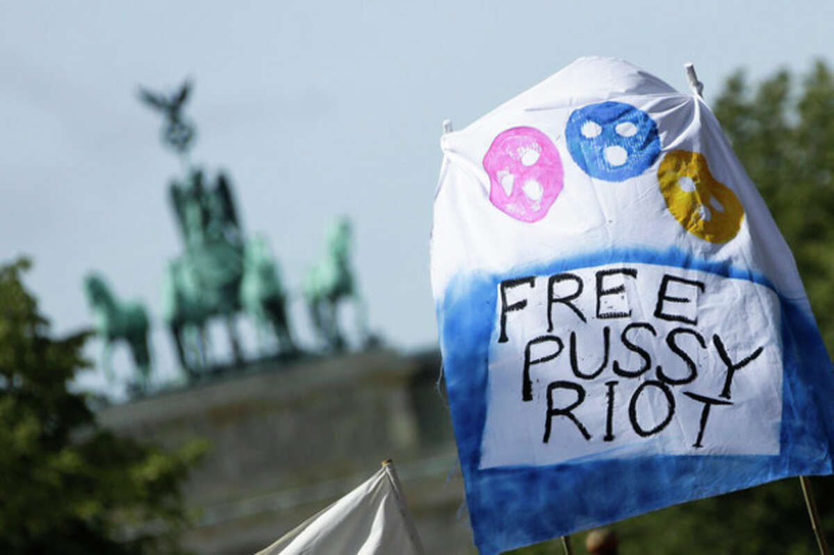 A demonstrator holds a banner in front of the Quadriga of the Brandenburg Gate, in support of the Russian punk group Pussy Riot, whose members face prison for a stunt against President Vladimir Putin, outside Russia's embassy in Berlin, Friday, Aug. 17, 2012. The three female band members have been in jail for more than five months because of an anti-Putin prank in Moscow's main cathedral. A judge is due to rule on their case Friday. (AP Photo/Markus Schreiber)