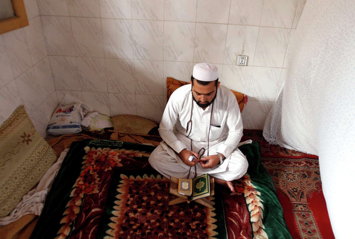 An Afghan Muslim devotee lives and prays in isolation in a mosque during Itikaf, the last ten days of the Islamic fasting month of Ramadan, in the city of Jalalabad east of Kabul, Afghanistan, Tuesday, Aug. 14, 2012. The last ten days of Ramadan, known as Itikaf, are very important according to many Muslims due to the belief that Prophet Muhammad used to exert himself even more in worship, hoping to draw himself closer to God. Itikaf involves total dedication to worship, reading Quran, and supplication. (AP Photo/Rahmat Gul)